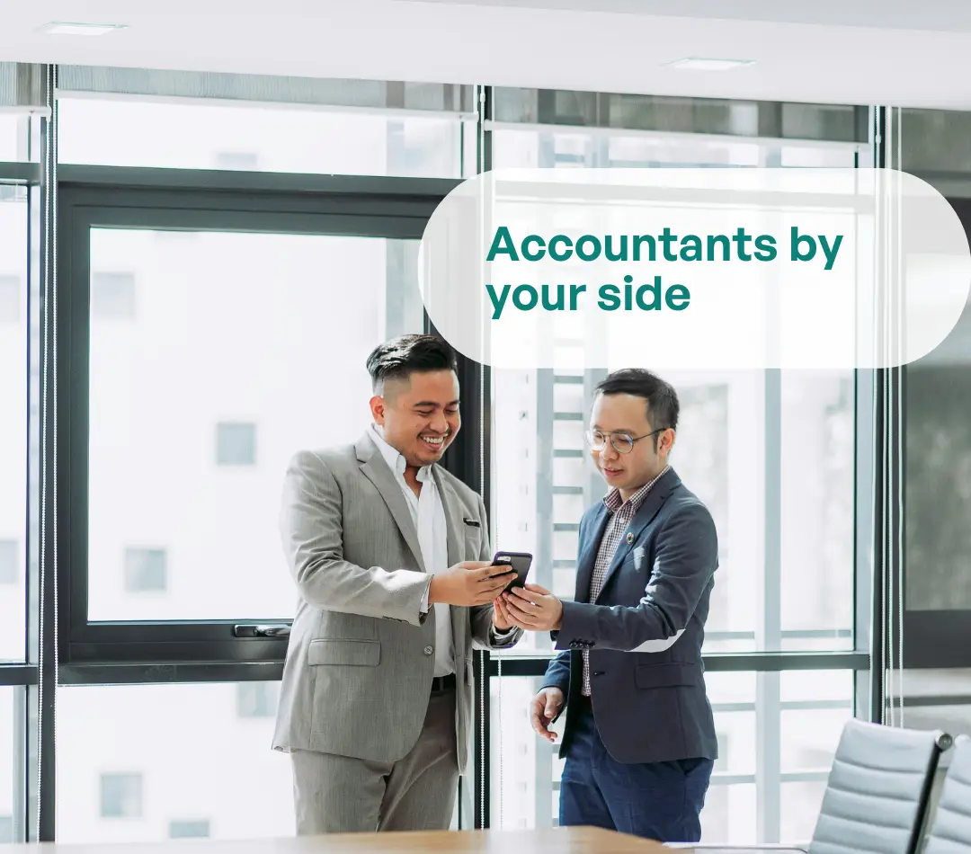 Accountants by your side. Two professionals reviewing a phone in a modern office.