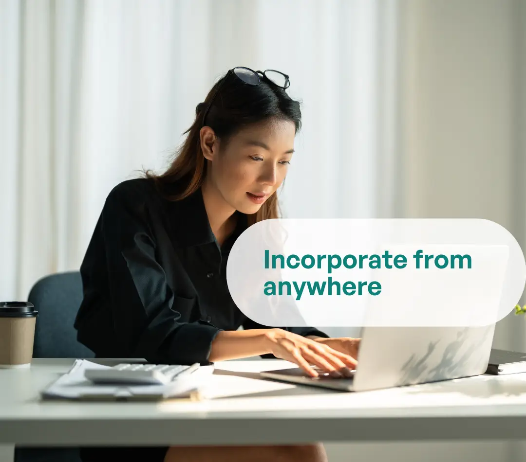 Person working on a laptop; text overlay reads ‘Incorporate from anywhere’.